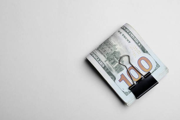 istock Dollar banknotes with paper clip on white background, top view 1442530737