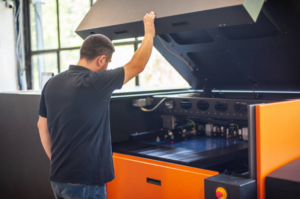 istock Professional worker with modern offset printing machine in print house 1442531068