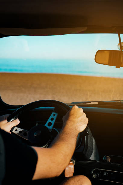 istock man driving a classic car on a dirt road 1442532095