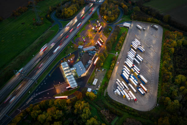 istock Highway and rest area at dusk - aerial view 1442534431