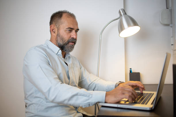 istock Senior fashionable man working at home 1442537535