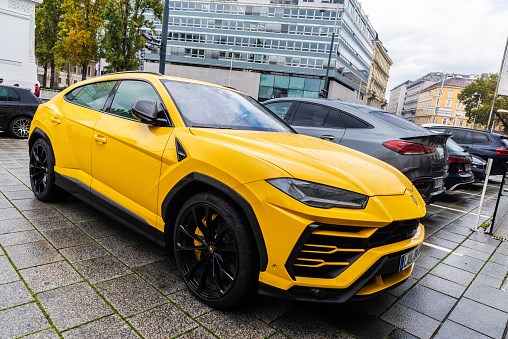 Vienna, Austria - October 14, 2022: Yellow Lamborghini Urus car parked on a street in Vienna, Austria