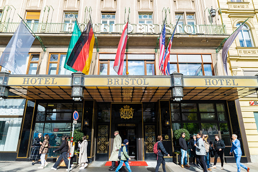 Vienna, Austria - October 14, 2022: Facade of the Bristol Hotel, a classic building with people around in Karntner Ring, Vienna, Austria