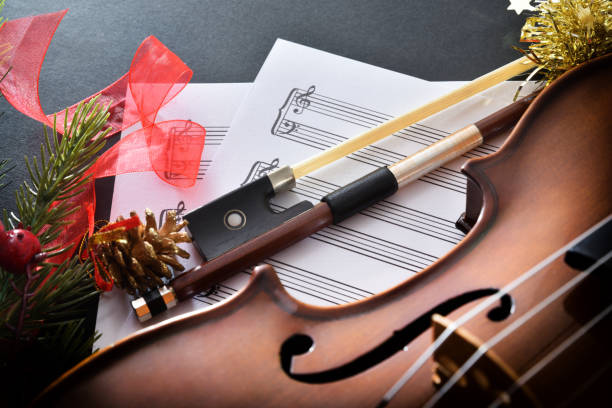 istock Violin on sheet music with Christmas decoration elevated view 1442551650