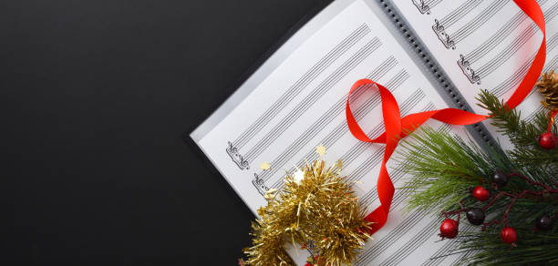 istock Choral christmas performance concept with sheet music on black table 1442551740