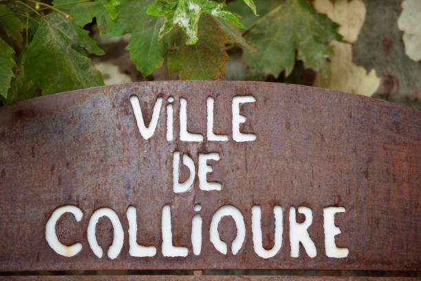 City of Collioure Nameplate Weathered Metal Sign, Collioure, Cote Vermeille, Languedoc-Roussillon, France Cut-out lettering, weathered and distressed metal nameplate sign for the Mediterranean resort of Collioure, in South West France. The  tourist resort is a town on the Cote Vermeille in the region of Pyrenees Orientales. In the 20th century Collioure became a creative hub of artistic activity, with several Fauve artists, amongst others making Collioure their home. Those in residence were André Derain, Georges Braque, Othon Friesz, Henri Matisse, Pablo Picasso, and the multi-talented, Charles Rennie Mackintosh. The sign is framed by leaves of a Plane Tree. collioure stock pictures, royalty-free photos & images