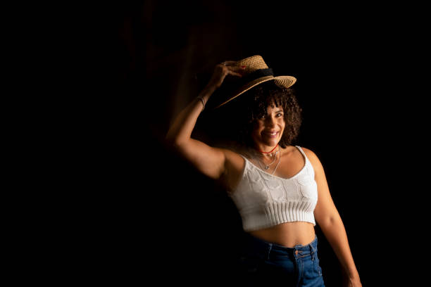 Time-lapse view of woman moving a hat. Long exposure, motion blur. Happy woman. Salvador, Brazil.