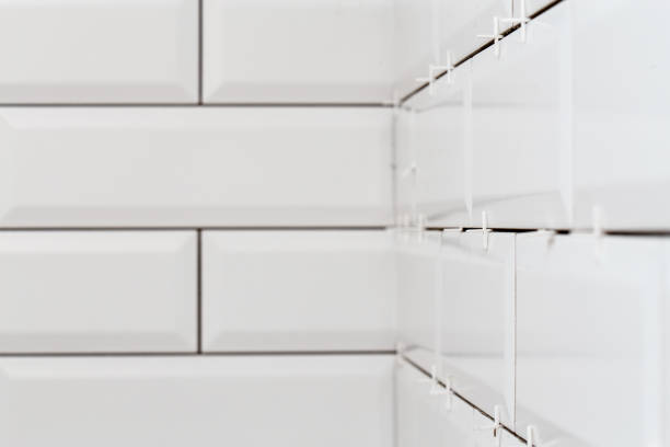 istock New white tiles in the bathroom. Wall decoration process. Home repairs. 1442558526