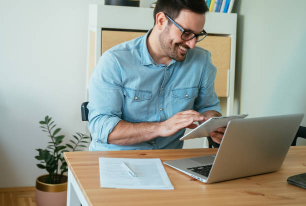 istock Happy Business Man Using A Digital Tablet In The Living Room 1442558997