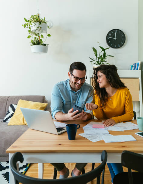 istock Happy Couple Paying Bills At Home 1442558999