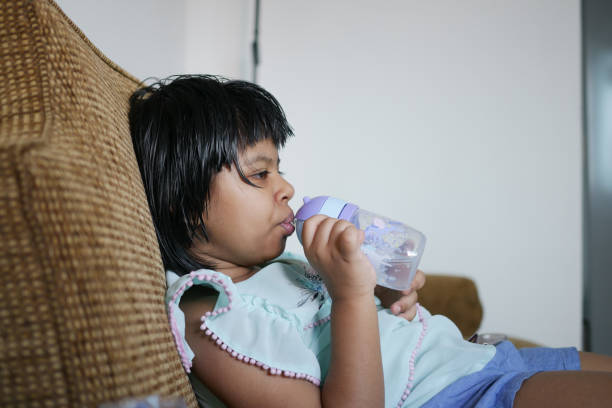 rear view child girl drinking water