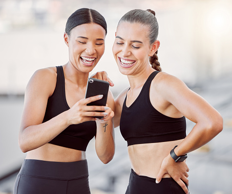 Relax, sports women and friends on social media app for chill break together at fitness training. Interracial girl friendship fun, leisure and internet entertainment for workout rest.