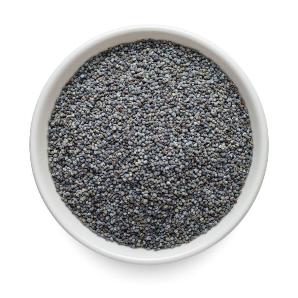 Poppy seeds in white bowl isolated on white background. Top view.