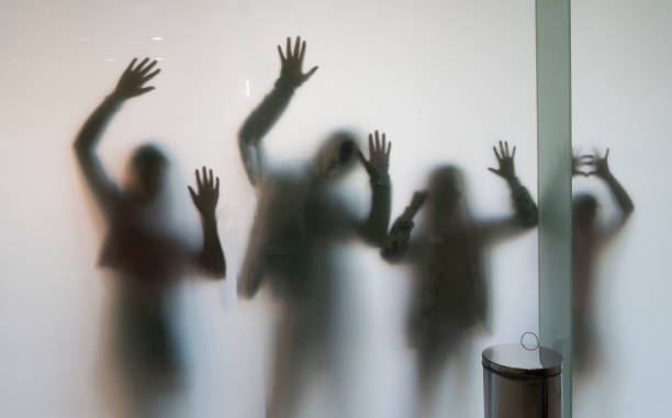 istock shadows of human figures, backlit children's bodies with open hands and raised arms 1442561679