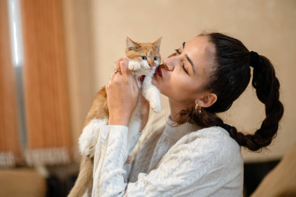 istock Young female pet owner cuddling with cat 1442562133