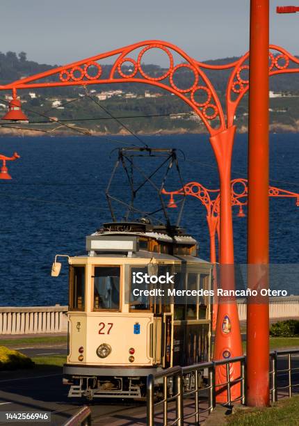 Oldfashioned Tram And Red Street Lights In A Row Seascape In The Background Stock Photo - Download Image Now