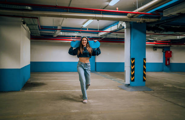 istock Smiling girl with skateboard 1442567011