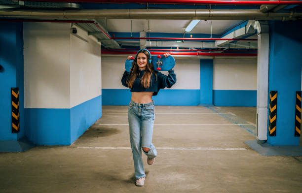 istock Smiling girl with skateboard 1442567060