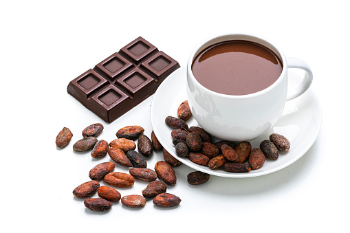 Sweet food: high angle view of a hot chocolate mug, cocoa beans and chocolate bar isolated on white background. High resolution 42Mp studio digital capture taken with Sony A7rII and Sony FE 90mm f2.8 macro G OSS lens