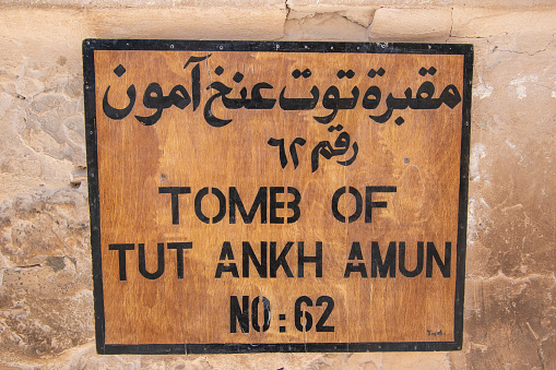 Valley of the Kings, Luxor, Egypt - July 22, 2022: The tomb of Tutankhamun, also known by its tomb number, KV62, is the burial place of Tutankhamun (reigned c. 1334–1325 BC), a pharaoh of the Eighteenth Dynasty of ancient Egypt, in the Valley of the Kings. The tomb consists of four chambers and an entrance staircase and corridor. It is smaller and less extensively decorated than other Egyptian royal tombs of its time, and it probably originated as a tomb for a non-royal individual that was adapted for Tutankhamun's use after his premature death. The Valley of the Kings is a valley in Egypt where, for a period of nearly 500 years from the 16th to 11th century BC, rock-cut tombs were excavated for the pharaohs and powerful nobles of the New Kingdom (the Eighteenth to the Twentieth Dynasties of Ancient Egypt). The valley stands on the west bank of the Nile opposite Thebes (modern Luxor), within the heart of the Theban Necropolis. The wadi consists of two valleys: the East Valley (where the majority of the royal tombs are situated) and the West Valley (Valley of the Monkeys)