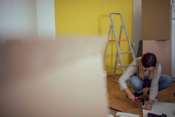 istock A woman uses hand tools when assembling furniture in the apartment 1442569587