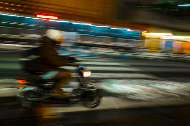 istock YOUNG MAN DRIVING HIS SCOOTER AT NIGHT IN TORONTO 1442570678
