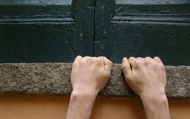 istock two hands clinging to a window sill, concept of risk or strength 1442570756
