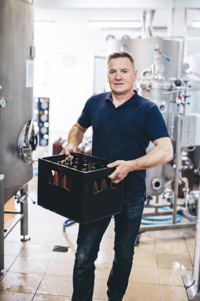 istock Brewery owner with crate of craft beer 1442571391