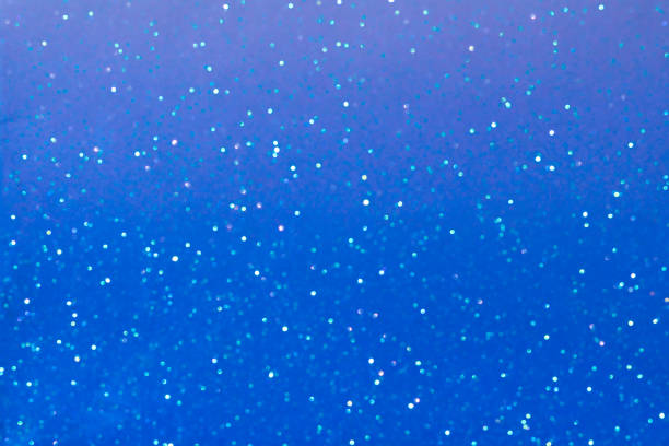 istock Blurred blue background with small bokeh. Defocused light, selective focus. Christmas, New Year, holidays. Copy space 1442573682