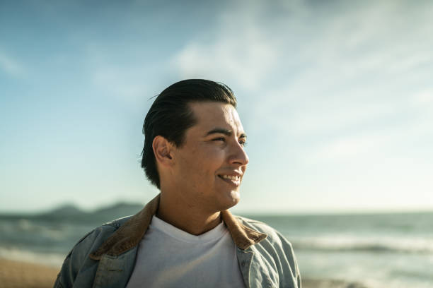 istock Young man looking away at the beach 1442574141