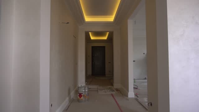 Modern renovation in an apartment with a stretch ceiling with LED lighting. Construction materials, remodeling of the hallway. Background