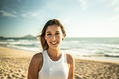 istock Portrait of young woman at the beach 1442579038