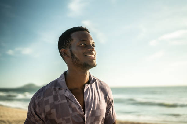 istock Young man looking away at the beach 1442580099