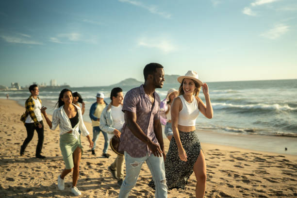 istock Young friends walking along the beach 1442580125