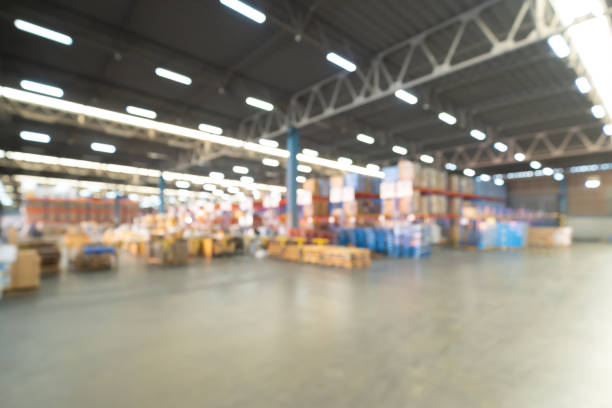 Blurry bokeh abstract background of interior of large warehouse retail store industry. Rack of furniture and home accessories stock storage. Interior of cargo in ecommerce and logistic concept. Depot stock photo