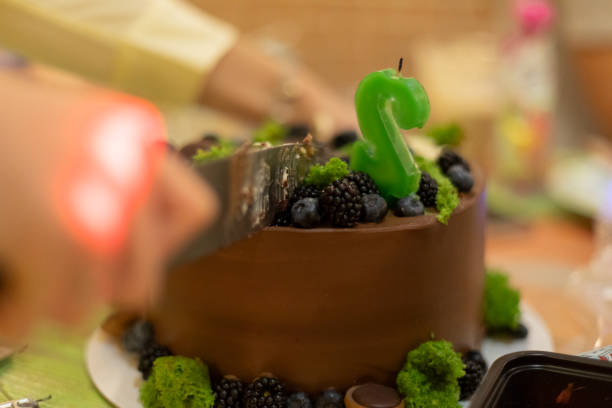 istock Chocolate cake. Cutting sweet cake. Treat to tea. Sweets on table. 1442586028