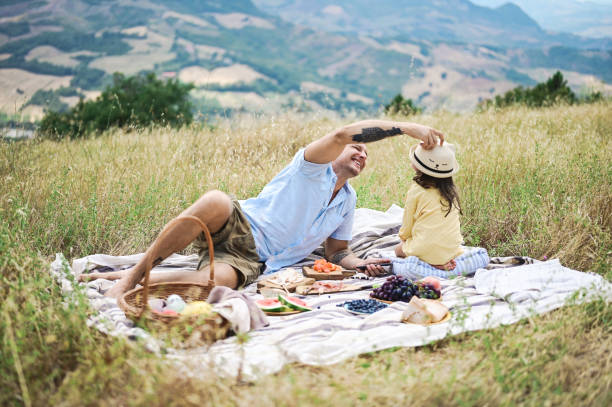 istock father with daughter relaxing and spending the weekend in nature. 1442588741
