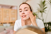 Young woman peeling and cleaning skin on face. Skin Care
