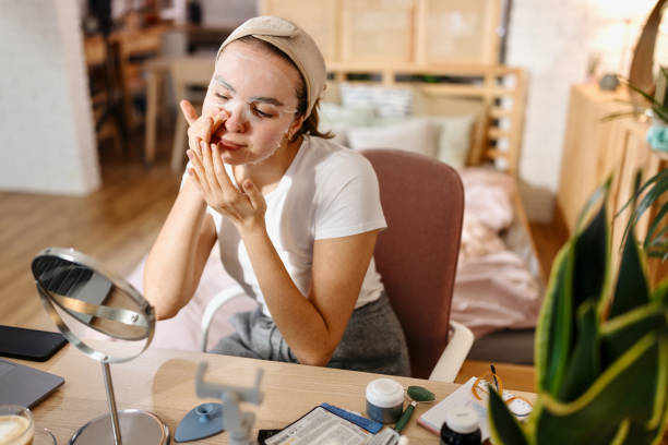 istock Young woman applying face mask at home 1442590314