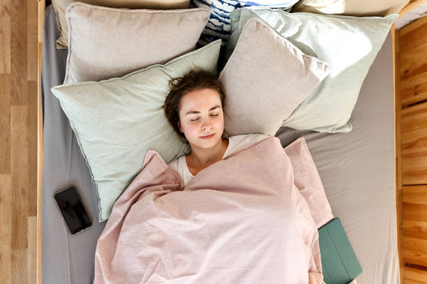 istock Young woman sleeping in bed 1442590552