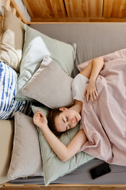istock Young woman sleeping in bed 1442590557
