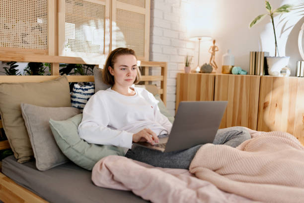 istock Young Woman Using Laptop in the Bed 1442590697