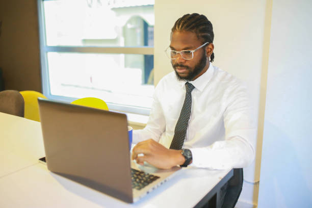 istock african american young banker man working on his computer in the office 1442591880