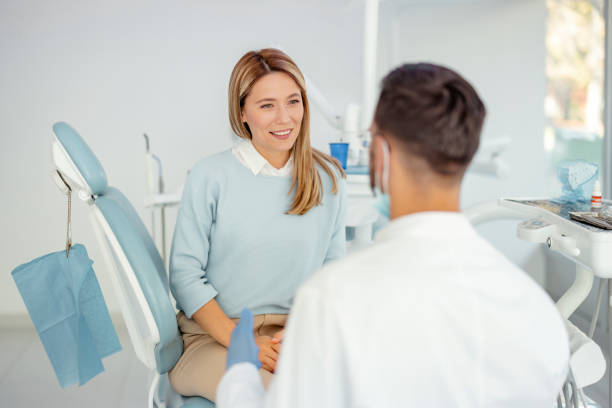 istock Female Patient Talking with Dentist 1442592977