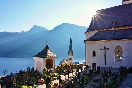 The cemetery in Hallstatt. The sun's rays shine on the cemetery in Hallstatt, Austria. Autumn sunny day in Hallstatt, Austria. A neat, beautiful cemetery with views of the lake and mountains in autumn.