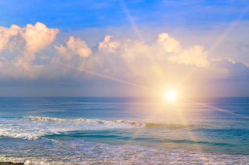 Sunrise over the sea background. Rolling waves on the shore with the colorful ocean beach.