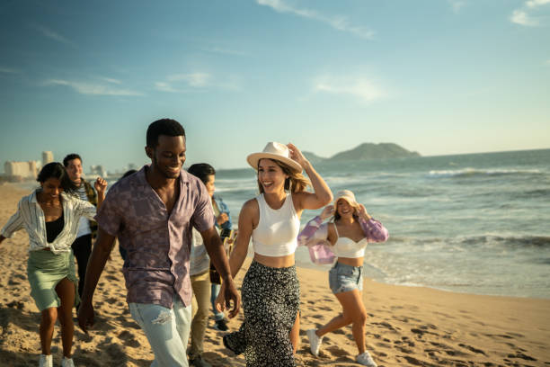 Young friends walking along the beach