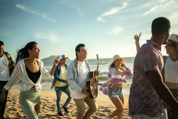 Young friends walking along the beach
