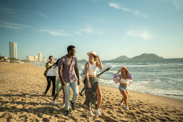 istock Young friends walking along the beach 1442599366