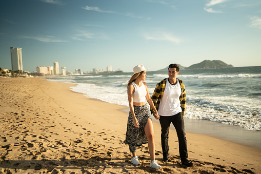 Young couple walking along the beach